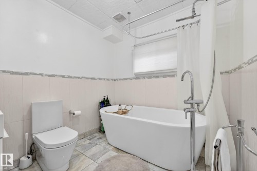 Bathroom with toilet and wainscoting - 10523 127 Street, Edmonton, AB - Indoor Photo Showing Bathroom