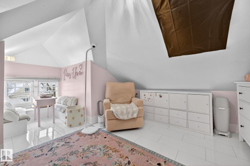 Bedroom with vaulted ceiling and light tile patterned floors - 10523 127 Street, Edmonton, AB - Indoor Photo Showing Other Room