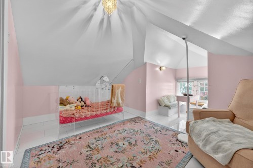 Tiled bedroom featuring vaulted ceiling and baseboards - 10523 127 Street, Edmonton, AB - Indoor