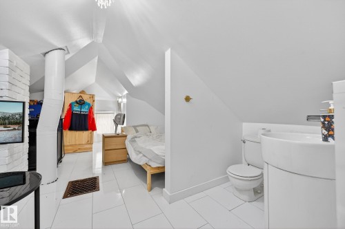Ensuite bathroom with vanity, lofted ceiling, and light tile patterned floors - 10523 127 Street, Edmonton, AB - Indoor Photo Showing Bathroom