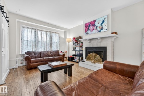 Living room with hardwood / wood-style floors and a fireplace - 10523 127 Street, Edmonton, AB - Indoor Photo Showing Living Room With Fireplace