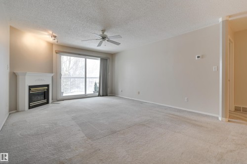 303 8811 106A Avenue, Edmonton, AB - Indoor Photo Showing Living Room With Fireplace