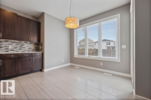 Unfurnished dining area with baseboards and a textured ceiling - 7515 178 Avenue, Edmonton, AB - Indoor Photo Showing Other Room