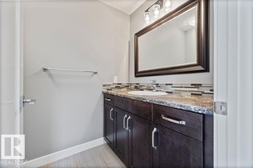 Bathroom with vanity and tasteful backsplash - 7515 178 Avenue, Edmonton, AB - Indoor Photo Showing Bathroom