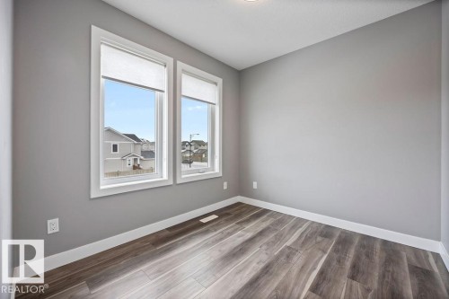 Unfurnished room featuring dark wood-type flooring - 7515 178 Avenue, Edmonton, AB - Indoor Photo Showing Other Room