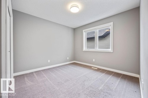 Empty room featuring light carpet and a textured ceiling - 7515 178 Avenue, Edmonton, AB - Indoor Photo Showing Other Room