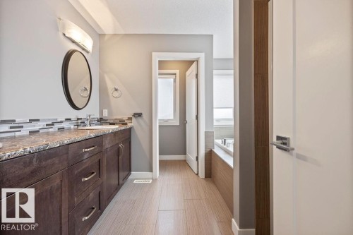 Full bathroom with vanity, a garden tub, and decorative backsplash - 7515 178 Avenue, Edmonton, AB - Indoor Photo Showing Bathroom