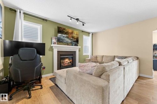 1150 35A Avenue, Edmonton, AB - Indoor Photo Showing Living Room With Fireplace