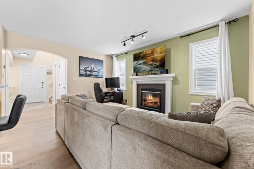 1150 35A Avenue, Edmonton, AB - Indoor Photo Showing Living Room With Fireplace