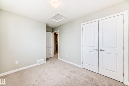 Unfurnished bedroom featuring light carpet and a closet - 3323 Roy Brown Way, Edmonton, AB - Indoor Photo Showing Other Room