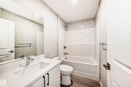 Full bath with vanity, tub / shower combination, and light wood-style floors - 3323 Roy Brown Way, Edmonton, AB - Indoor Photo Showing Bathroom