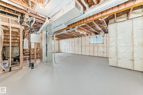 Below grade area with water heater and heating unit - 3323 Roy Brown Way, Edmonton, AB - Indoor Photo Showing Basement