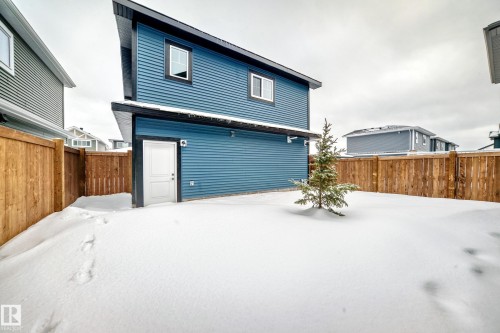 Snow covered back of property with a fenced backyard - 3323 Roy Brown Way, Edmonton, AB - Outdoor With Exterior