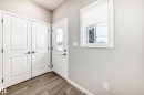 Doorway with wood finished floors and baseboards - 3323 Roy Brown Way, Edmonton, AB  - Indoor Photo Showing Other Room 