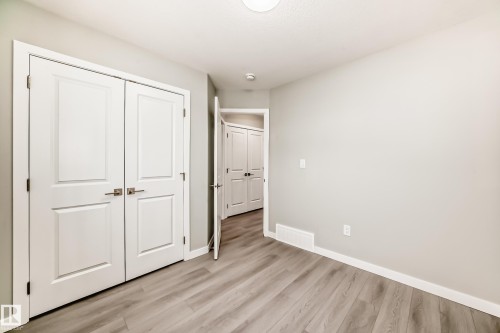 Unfurnished bedroom featuring light wood-style floors and a closet - 3323 Roy Brown Way, Edmonton, AB - Indoor Photo Showing Other Room