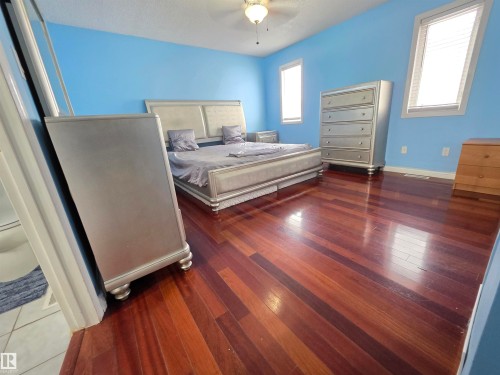 Bedroom featuring dark wood-type flooring and ceiling fan - 6731 162 Ave, Edmonton, AB - Indoor Photo Showing Bedroom