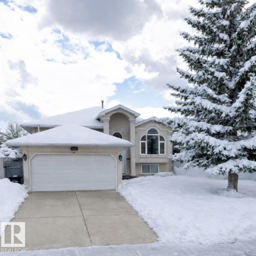 View of front facade with a garage, driveway, and stucco siding - 6731 162 Ave, Edmonton, AB - Outdoor With Facade
