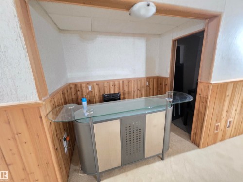 Bar area with wooden walls, a wainscoted wall, and a drop ceiling - 6731 162 Ave, Edmonton, AB - Indoor Photo Showing Other Room