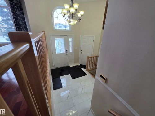 Foyer with a high ceiling, suspended lighting, and light marble finish flooring - 6731 162 Ave, Edmonton, AB - Indoor Photo Showing Other Room