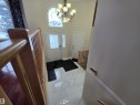 Foyer with a high ceiling, suspended lighting, and light marble finish flooring - 6731 162 Ave, Edmonton, AB  - Indoor Photo Showing Other Room 