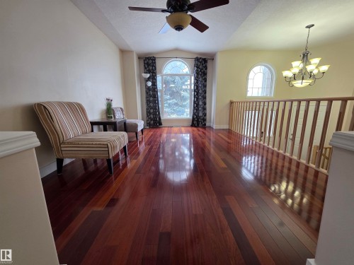 Sitting room featuring dark wood finished floors, a ceiling fan, and suspended lighting - 6731 162 Ave, Edmonton, AB - Indoor Photo Showing Other Room