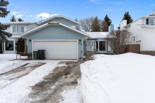 Traditional home with an attached garage, a chimney, covered porch, and driveway - 115 Walker Road, Edmonton, AB - Outdoor With Facade