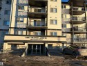 View of apartment building / complex with covered parking - 310 2430 Guardian Road, Edmonton, AB  - Outdoor With Balcony With Facade 