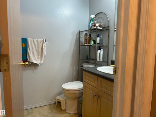 Half bath with vanity and toilet - 310 2430 Guardian Road, Edmonton, AB - Indoor Photo Showing Bathroom