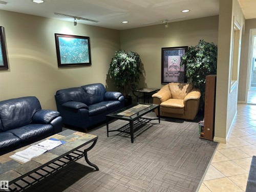 Living area featuring recessed lighting and light tile patterned floors - 310 2430 Guardian Road, Edmonton, AB - Indoor Photo Showing Living Room