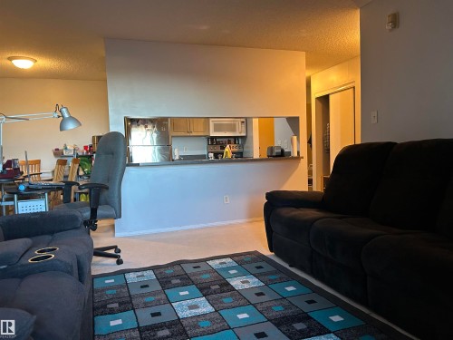 Living area featuring a textured ceiling - 310 2430 Guardian Road, Edmonton, AB - Indoor Photo Showing Other Room