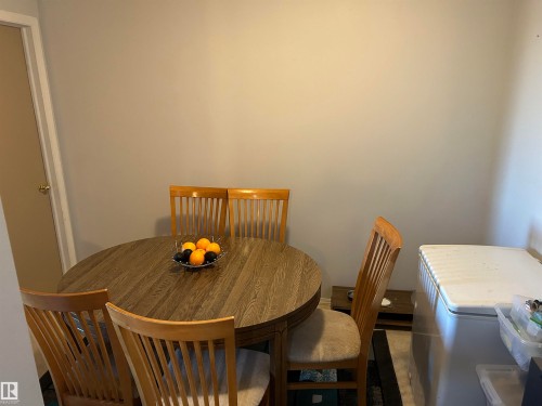 Dining area featuring washer / dryer - 310 2430 Guardian Road, Edmonton, AB - Indoor Photo Showing Dining Room
