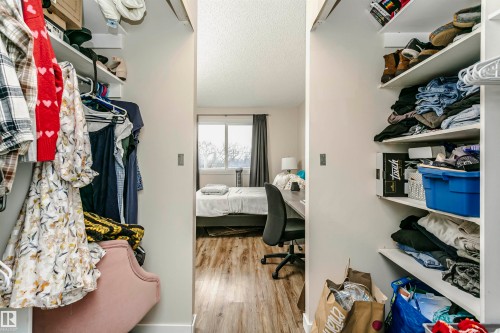 Walk in closet with light wood-type flooring - 407 8149 111 St S, Edmonton, AB - Indoor With Storage