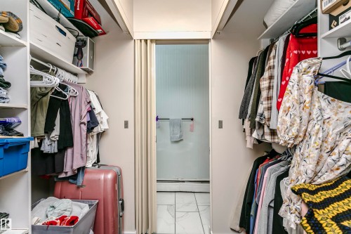 Walk in closet featuring light marble finish floors and a baseboard radiator - 407 8149 111 St S, Edmonton, AB - Indoor With Storage