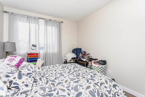 Bedroom featuring a textured ceiling and baseboards - 407 8149 111 St S, Edmonton, AB - Indoor Photo Showing Bedroom