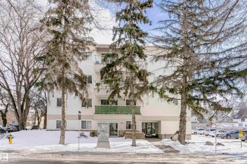 Snow covered property with a view of apartment building / complex - 407 8149 111 St S, Edmonton, AB - Outdoor