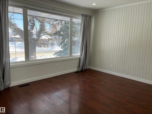 Unfurnished room with a textured ceiling, dark wood finished floors, and ornamental molding - 10832 163 Street, Edmonton, AB - Indoor Photo Showing Other Room