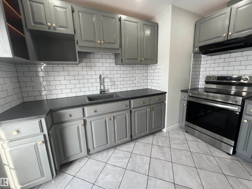 Kitchen featuring gray cabinetry, electric stove, and tasteful backsplash - 10832 163 Street, Edmonton, AB - Indoor Photo Showing Kitchen