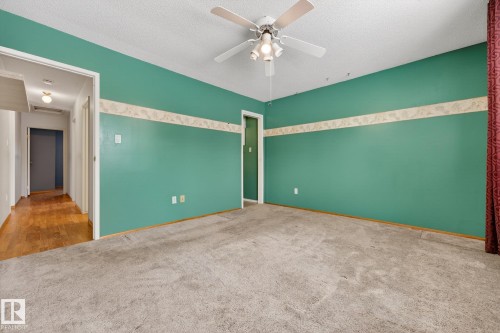 Empty room featuring carpet flooring, a ceiling fan, and a textured ceiling - 21 Marchand Place, St. Albert, AB - Indoor Photo Showing Other Room