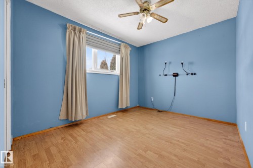 Spare room featuring light wood-style floors, a textured ceiling, and a ceiling fan - 21 Marchand Place, St. Albert, AB - Indoor Photo Showing Other Room