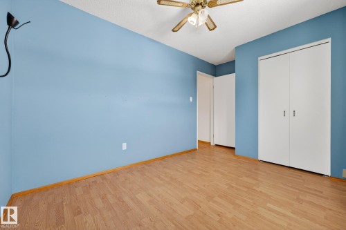 Unfurnished bedroom featuring light wood-style floors, ceiling fan, and a closet - 21 Marchand Place, St. Albert, AB - Indoor Photo Showing Other Room