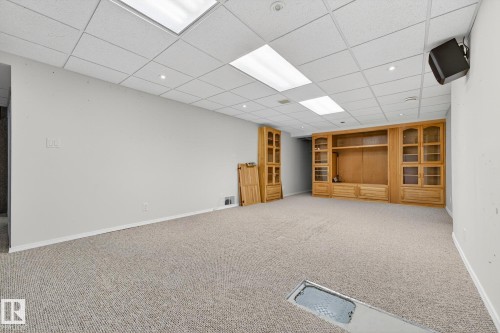 Finished basement with a drop ceiling and light colored carpet - 21 Marchand Place, St. Albert, AB - Indoor