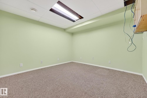 Empty room featuring a paneled ceiling and carpet - 21 Marchand Place, St. Albert, AB - Indoor Photo Showing Other Room