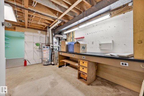 Unfinished below grade area featuring gas water heater and heating unit - 21 Marchand Place, St. Albert, AB - Indoor Photo Showing Basement