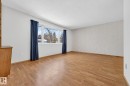 Empty room featuring a textured ceiling, light wood finished floors, and wallpapered walls - 21 Marchand Place, St. Albert, AB  - Indoor Photo Showing Other Room 