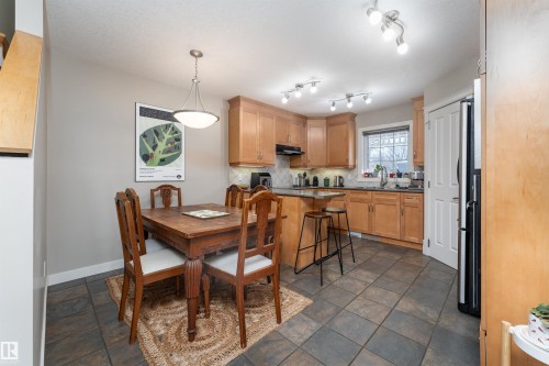 Dining area with baseboards and dark stone finish flooring - 10906 72 Avenue, Edmonton, AB - Indoor