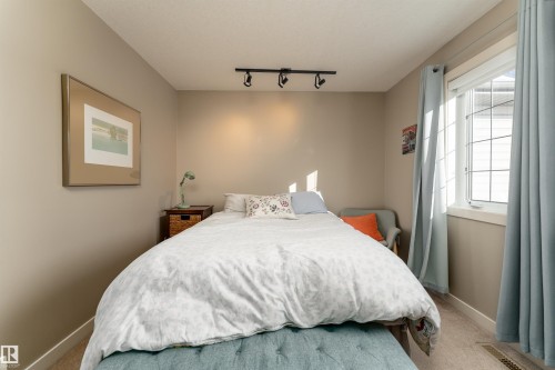 Bedroom with track lighting and carpet flooring - 10906 72 Avenue, Edmonton, AB - Indoor Photo Showing Bedroom
