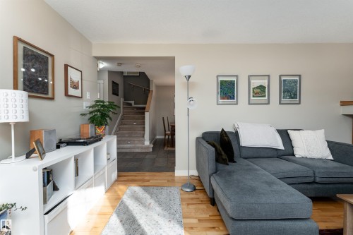 Living room with stairs and light wood-type flooring - 10906 72 Avenue, Edmonton, AB - Indoor Photo Showing Living Room