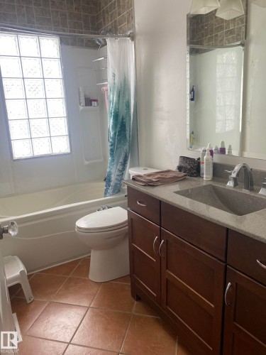 Full bathroom featuring vanity and shower / bath combination with curtain - 10945 54 Avenue, Edmonton, AB - Indoor Photo Showing Bathroom