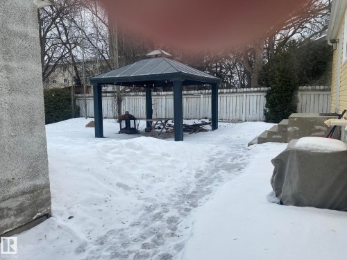 Snowy yard with a gazebo, a patio, and a fenced backyard - 10945 54 Avenue, Edmonton, AB - Outdoor