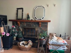 Stone-clad fireplace featuring a wood mantel - 